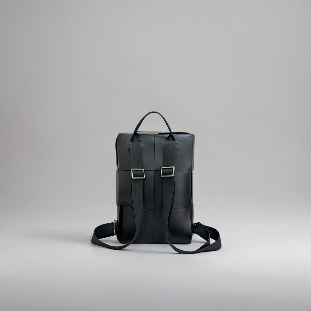 LS Fashion black leather rucksack shown from the back with adjustable straps and top handle