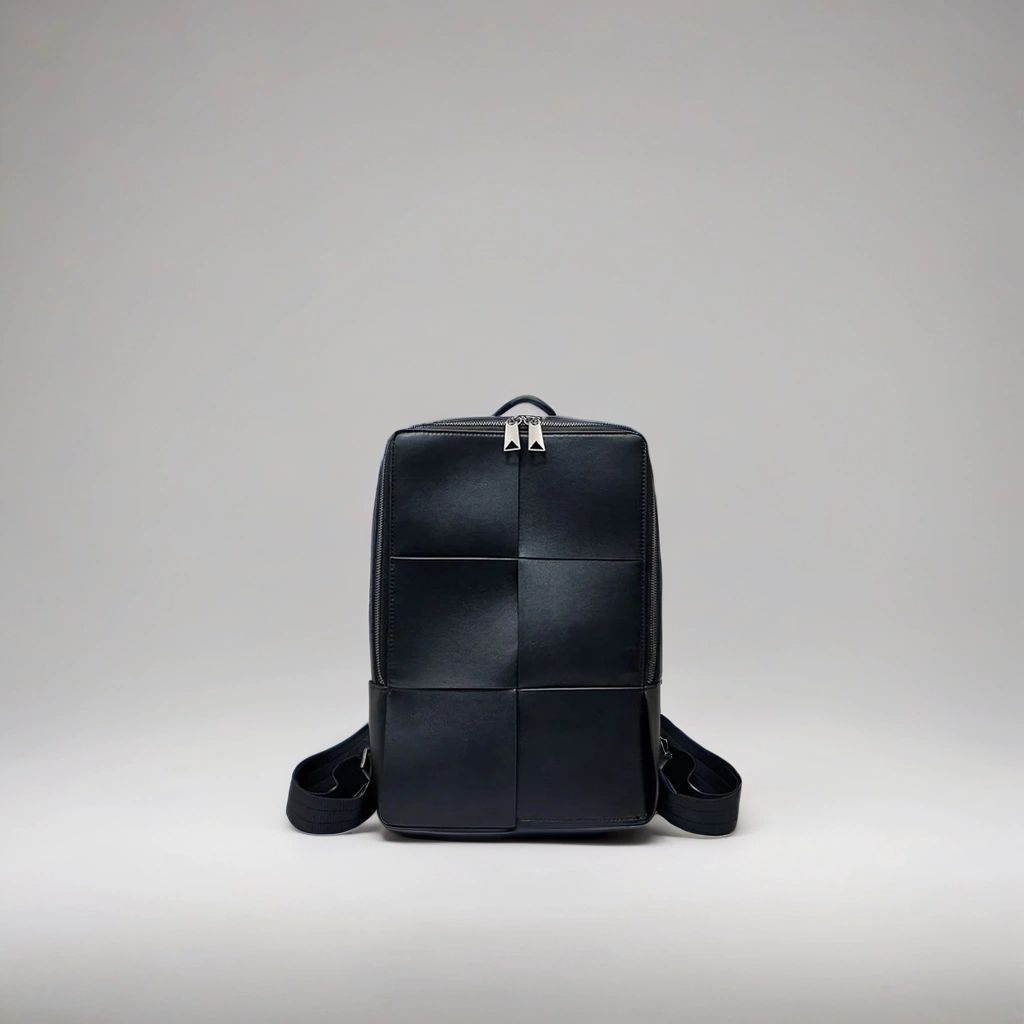 LS Fashion black leather rucksack with a sleek square patch design and silver zipper accents